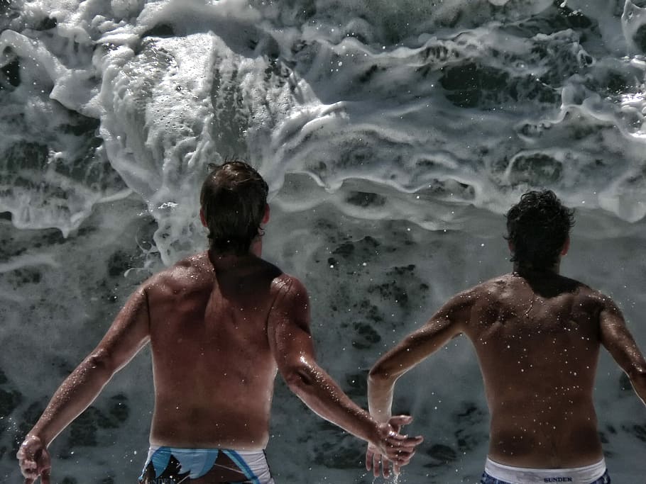 two person in front of wave, two person facing ocean waves, action HD wallpaper