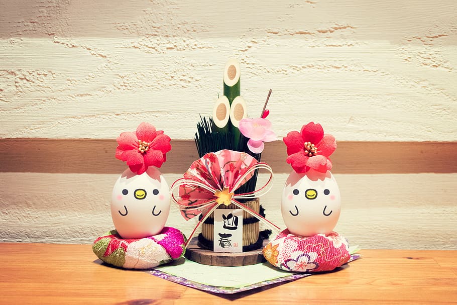 two decorative eggs in between potted bamboo with pink floral hand fan HD wallpaper