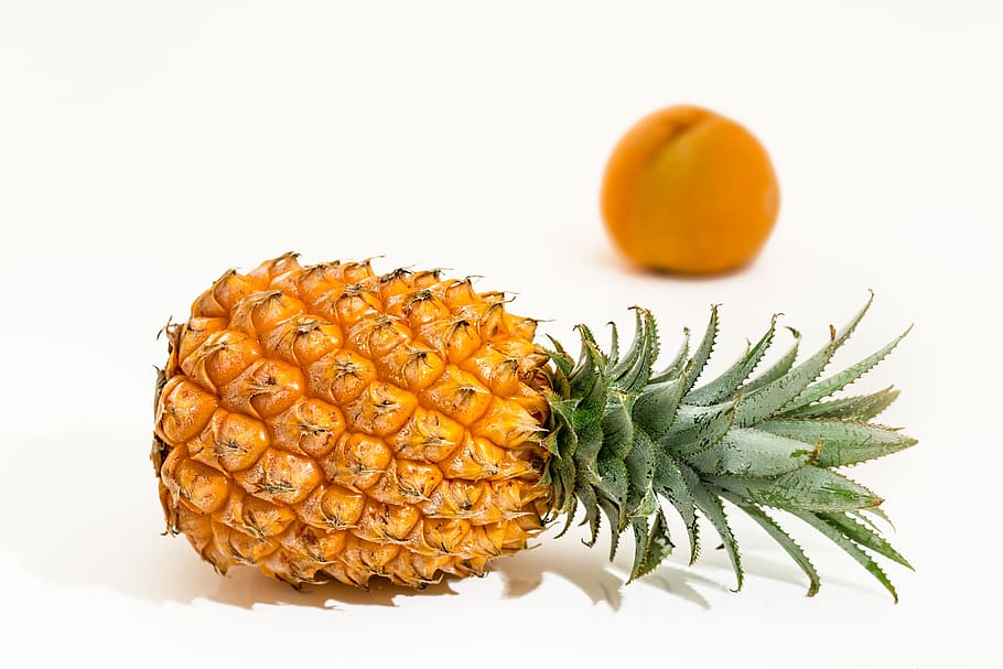 selective focus photography of ripe pineapple with orange fruit background, HD wallpaper