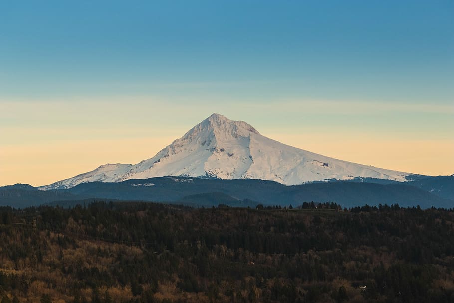 mountain covered by snow under blue sky, photo of mountain beside trees under clear blue sky during daytime HD wallpaper