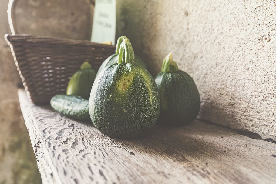 four green squash on wooden shelf, closeup photo of green fruits near basket HD wallpaper
