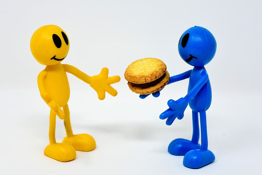 blue person figurine giving yellow person figurine hamburger