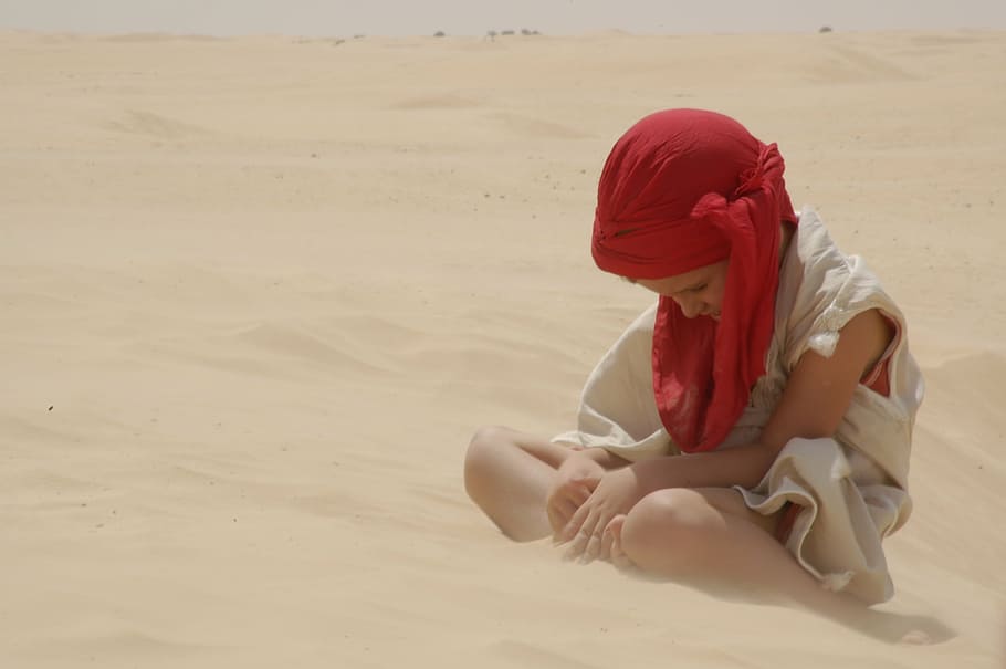 boy sitting on brown sand wearing white top, kid, red, sad HD wallpaper