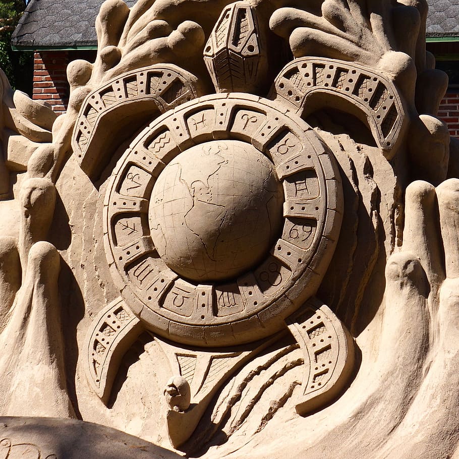 sand sculpture, work of art, hewn, the earth and the signs of the zodiac