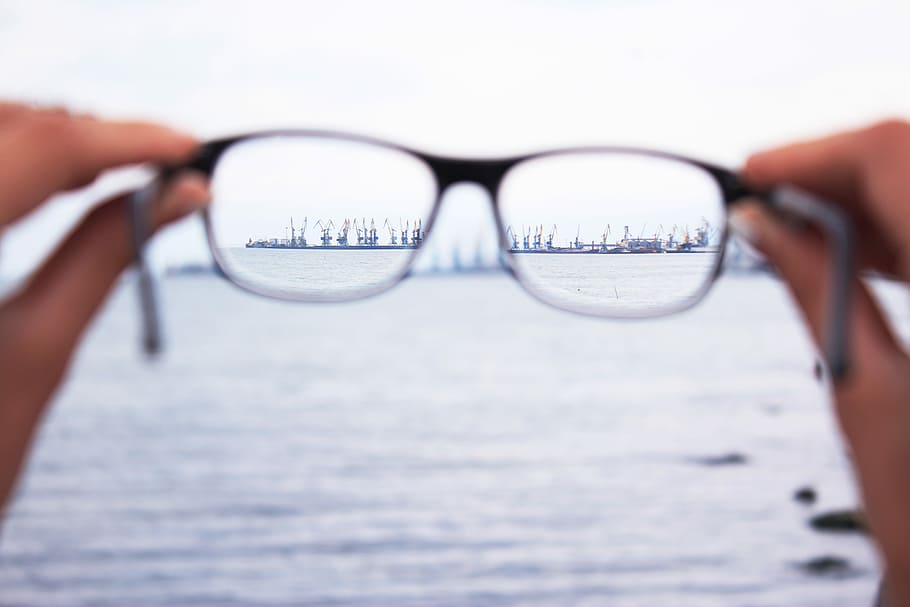 person holding eyeglasses, tilt shift lens of eyeglasses staring at ship HD wallpaper
