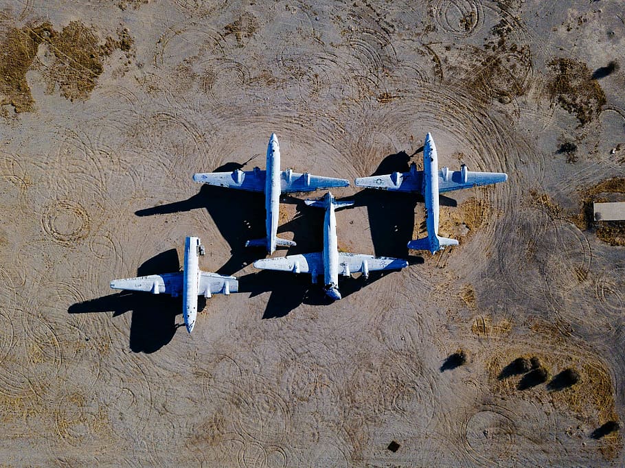 bird's-eye view photography of four white airliners, four white airplanes on ground during daytime HD wallpaper