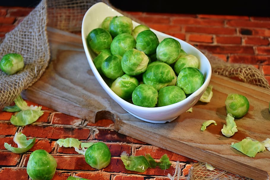 round green fruits on white ceramic bowl, brussels sprouts HD wallpaper
