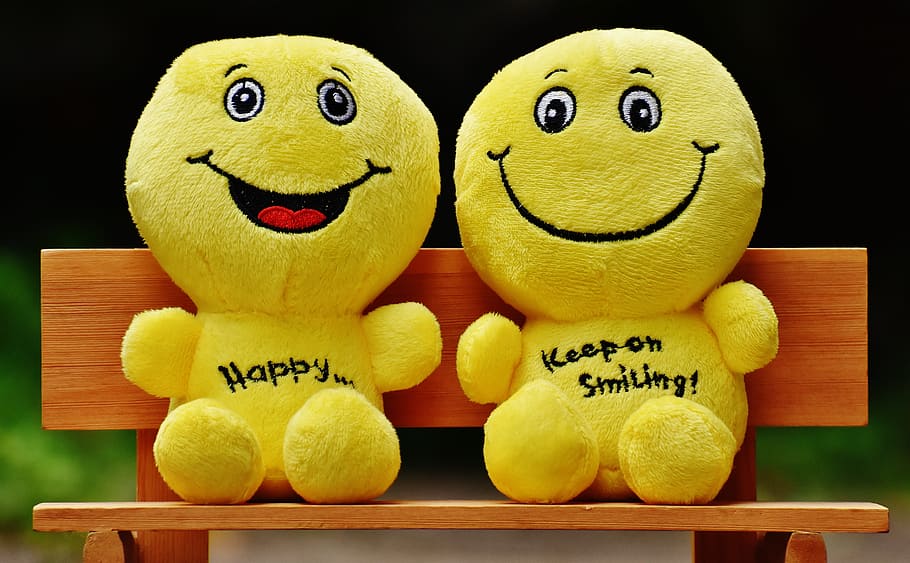 two emoji plush toys sitting on bench, smilies, bank, rest, friends