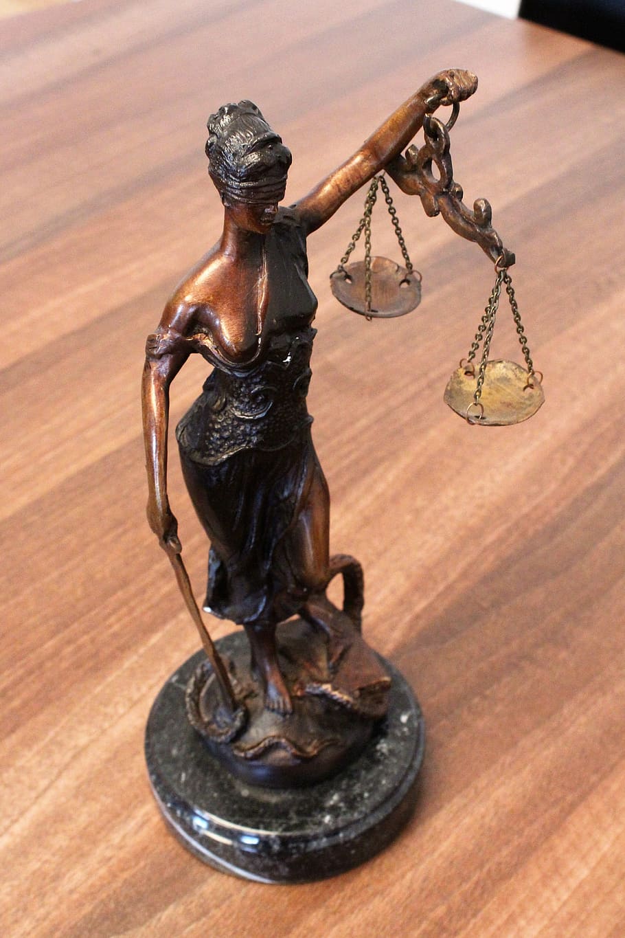 Lady of Justice figurine on table, justitia, justitia the goddess of
