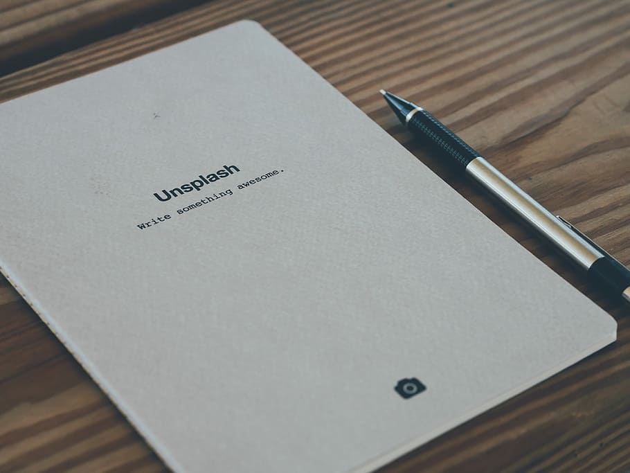 Unsplash pad on brown wooden surface, untitled, notebook, pen HD wallpaper