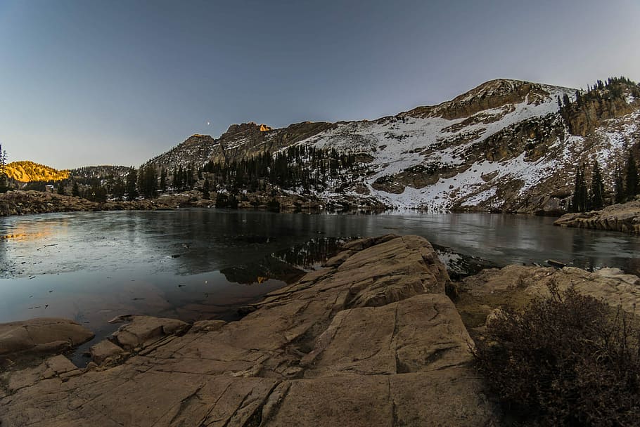 rockformation near lake under white sky, body of water beside brown and white mountain under clear blue sky, HD wallpaper