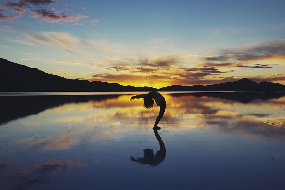silhouette photography of woman doing yoga, silhouette of person standing on body of water HD wallpaper