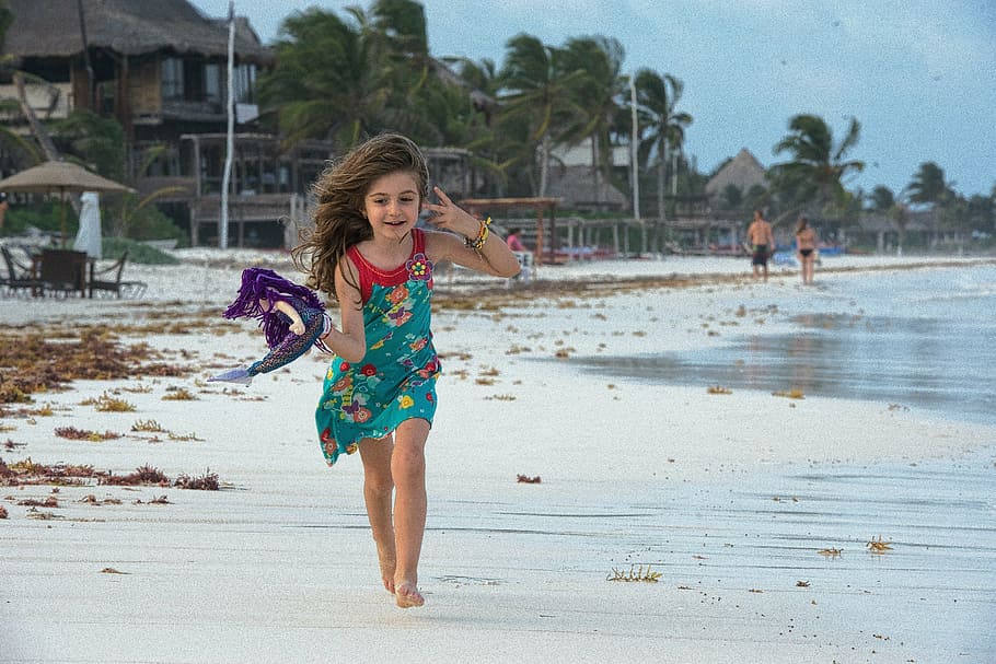 panning photography of girl holding purple textile running on seashore HD wallpaper
