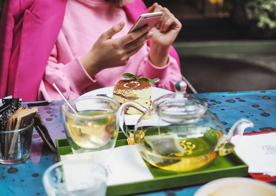 Enjoy The Café in Italy, human holding iPhone sitting on chair near table with teapot and mug HD wallpaper