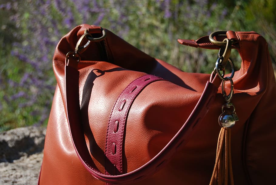 brown leather shoulder bag on gray soil, skin, day, focus on foreground HD wallpaper