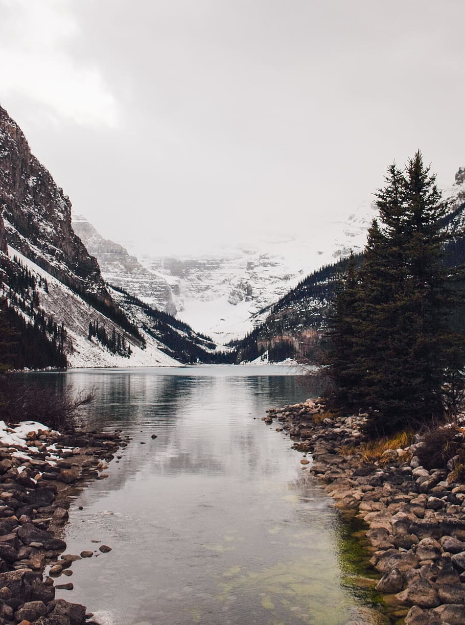 landscape photography of mountains and body of water, snow covered mountain across body of water during daytime HD wallpaper