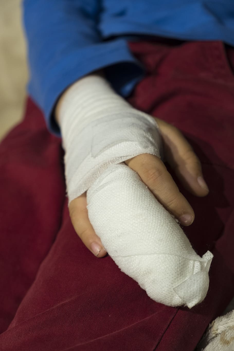 person wearing white hand cast, child, boy, injury, injured, association