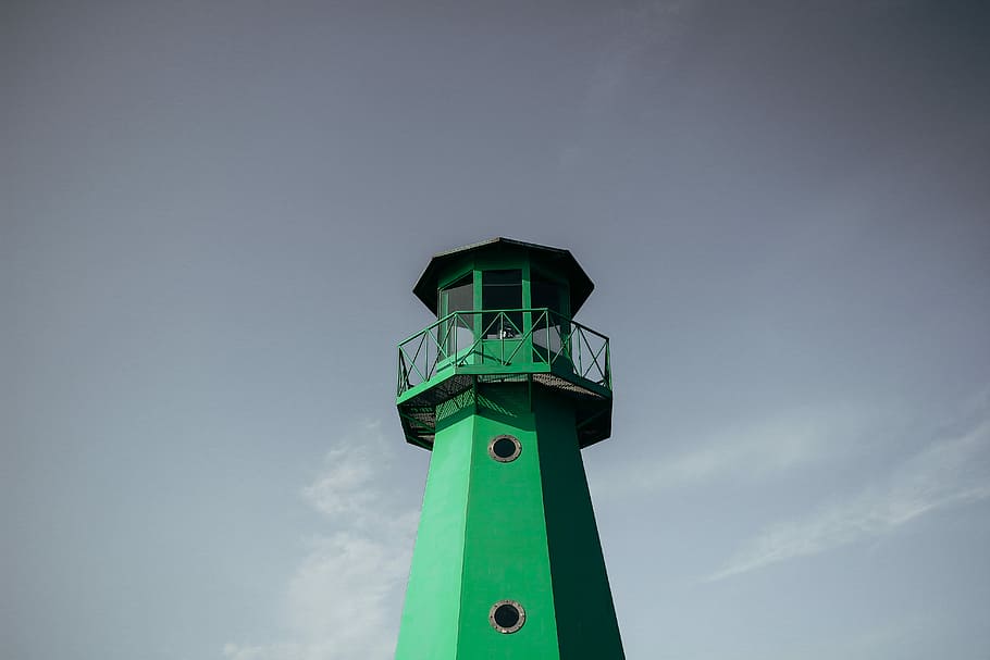 green lighthouse under cloudy sky during daytime, low angle photography of green lighthouse HD wallpaper