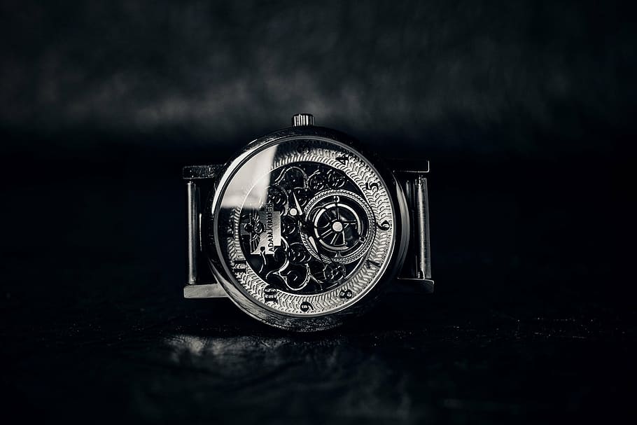 round silver-colored skeleton watch on black surface, time HD wallpaper