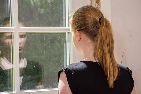 blonde haired woman wearing black sleeveless shirt facing white wood-framed clear glass window pane HD wallpaper