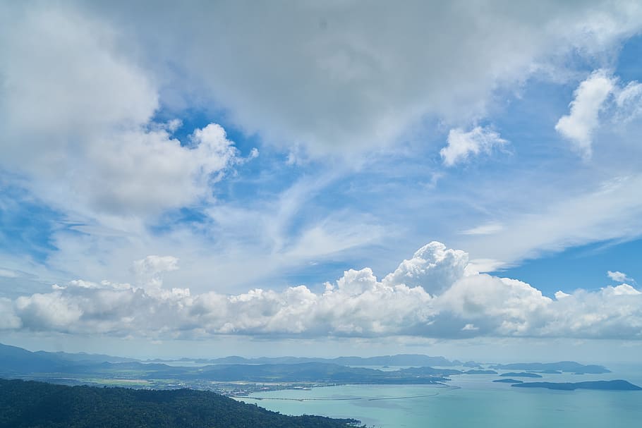body of water under white clouds and blue sky, cloudy, daytime