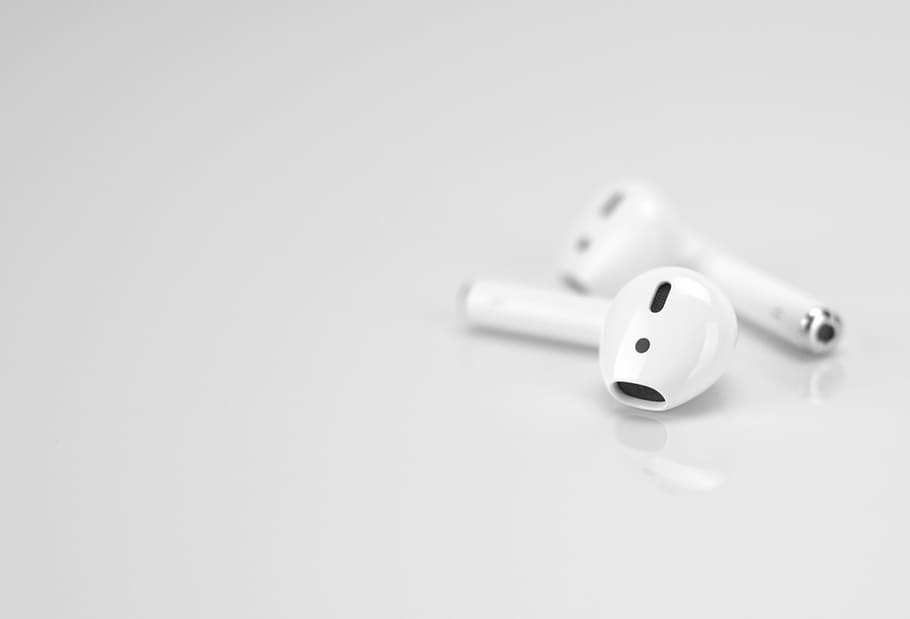 Apple AirPods on white surface, Apple AirPods, earpods, music