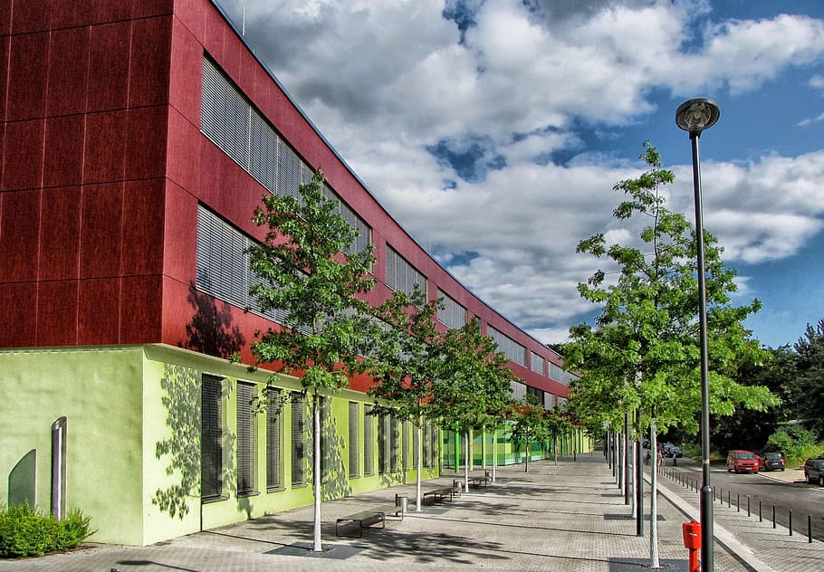 red and green concrete building near green trees duering daytime HD wallpaper