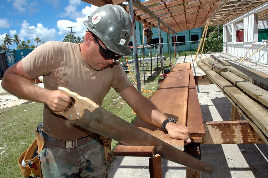 man holding wood saw, worker, construction, building, carpenter HD wallpaper