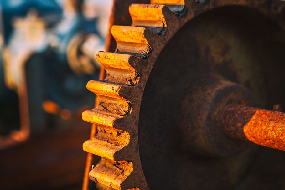 Close-up sunlit shot of an old rusty cog. Image captured in Dungeness, Kent, England HD wallpaper