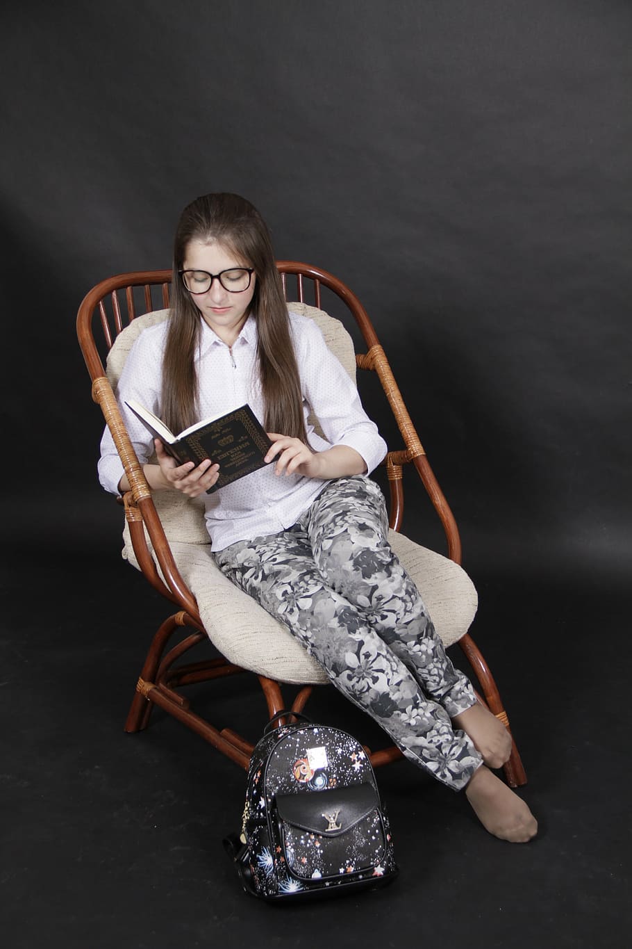 woman reading book while sitting on brown rattan chair, study HD wallpaper