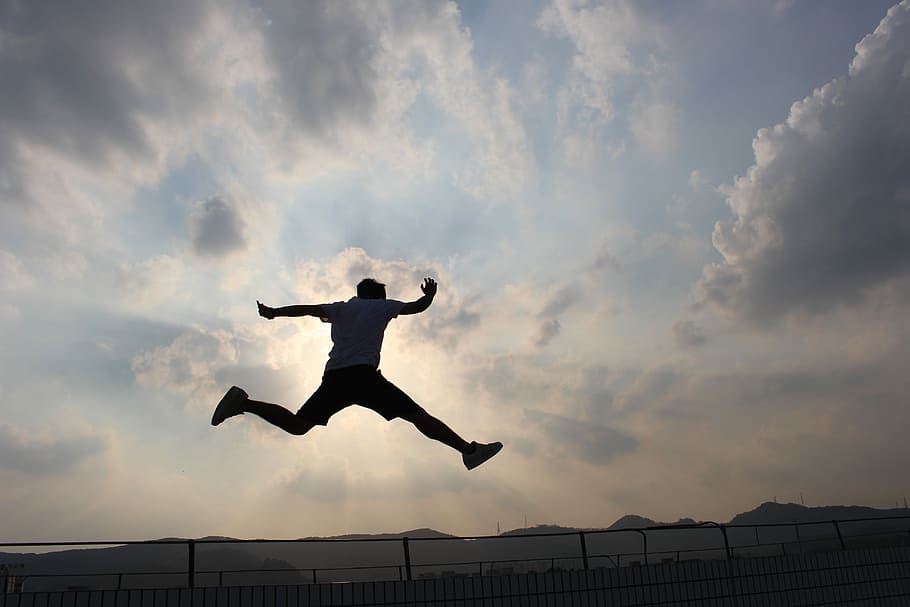 silhouette of man jumping on air under cloudy sky, Sunset, black HD wallpaper