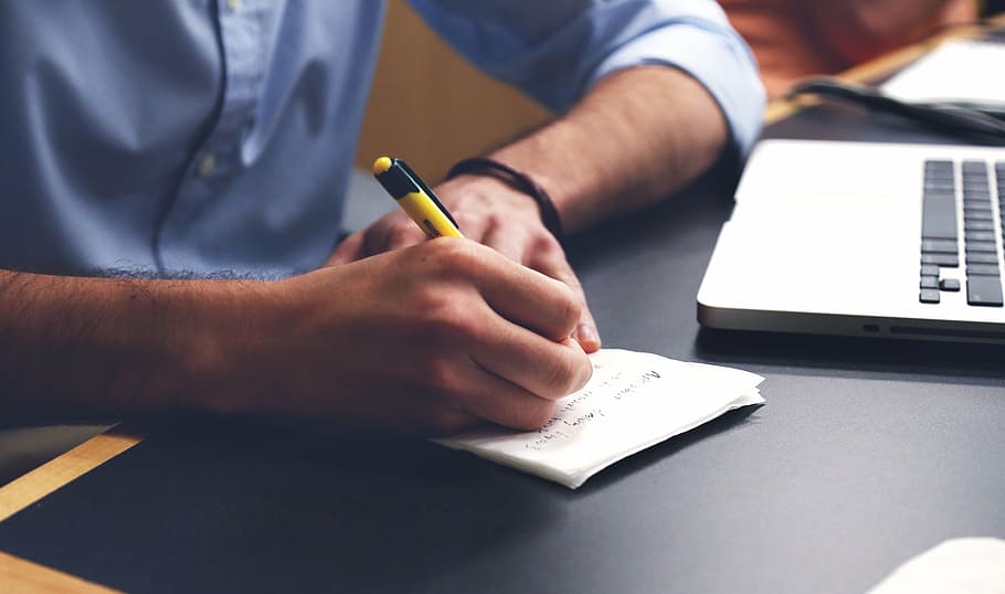 person writing on notes near MacBook Pro, man, white, paper HD wallpaper