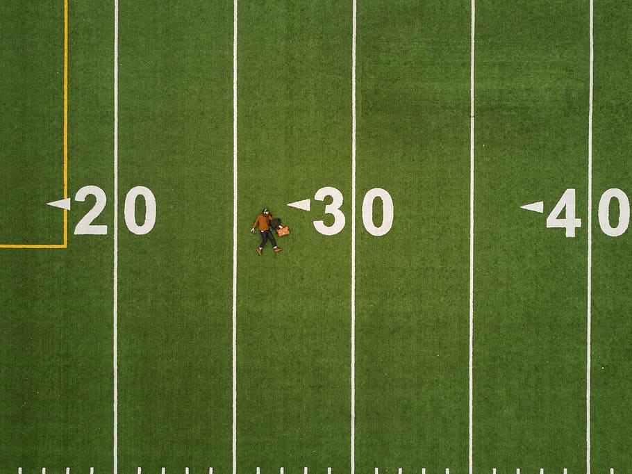 man lying on 30 yards on football field, man laying on football 30 yard, HD wallpaper
