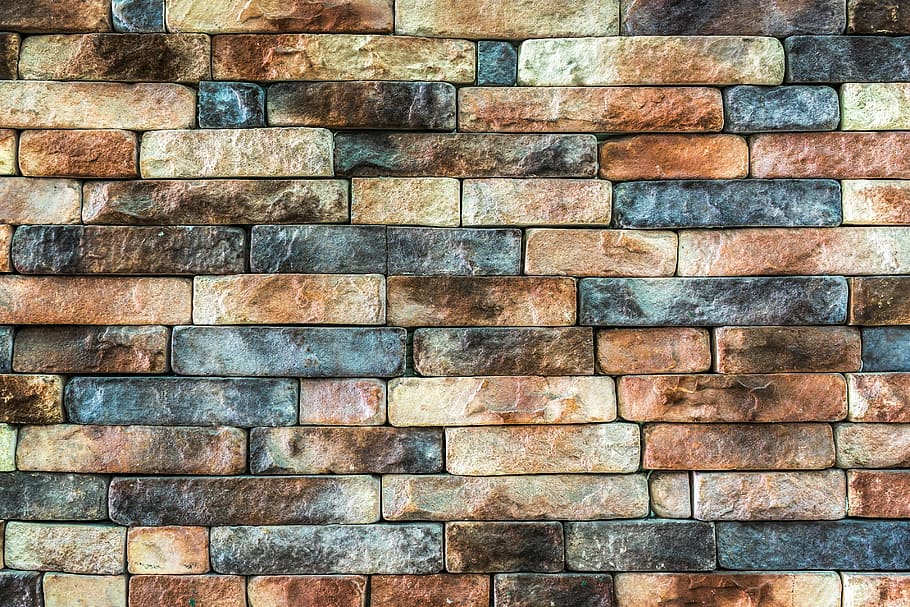 closeup photo of brown and black brick, wall, damme, stone wall