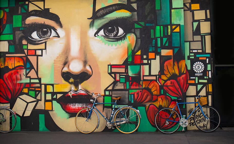 two blue cruiser bicycles on graffiti wall, women's face with roses wall painting, HD wallpaper