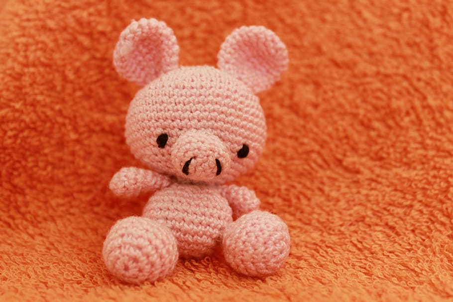 pink bear knitted plush toy on orange textile, crochet, pig, crocheted