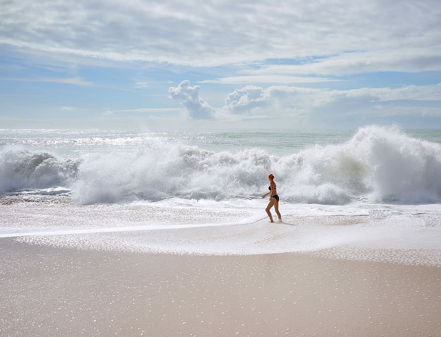 woman facing ocean waves, woman standing on seashore during daytime HD wallpaper