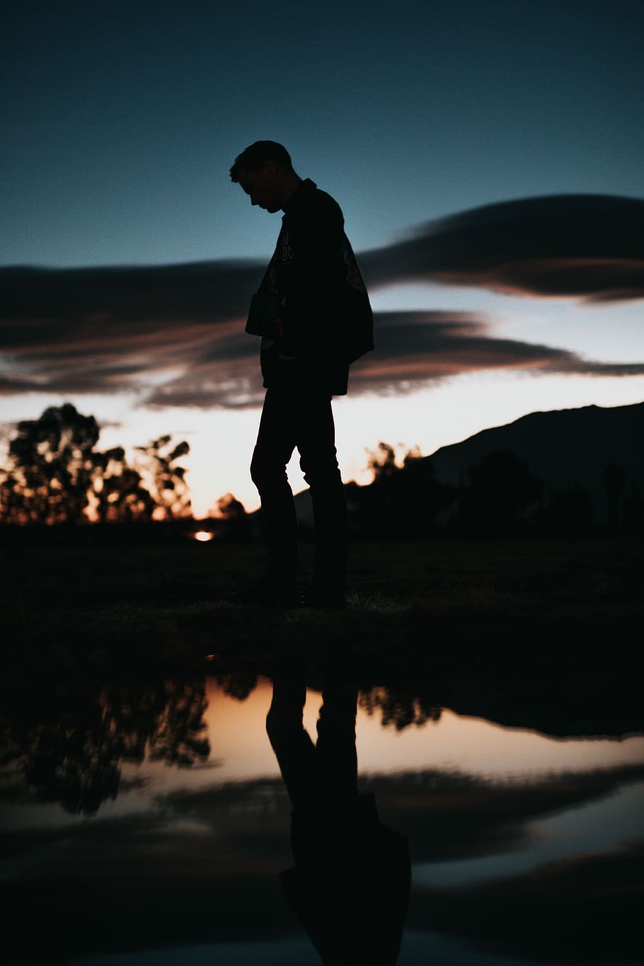 silhouette of man near body of water, silhouette of man wearing jacket and pants walking beside body of water HD wallpaper