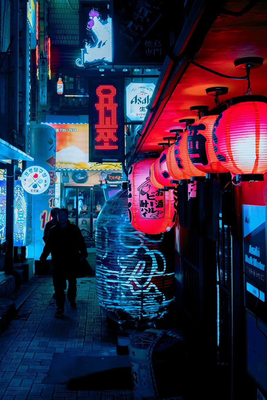 Seoul, silhouette of person walking in hallway street with neon signs