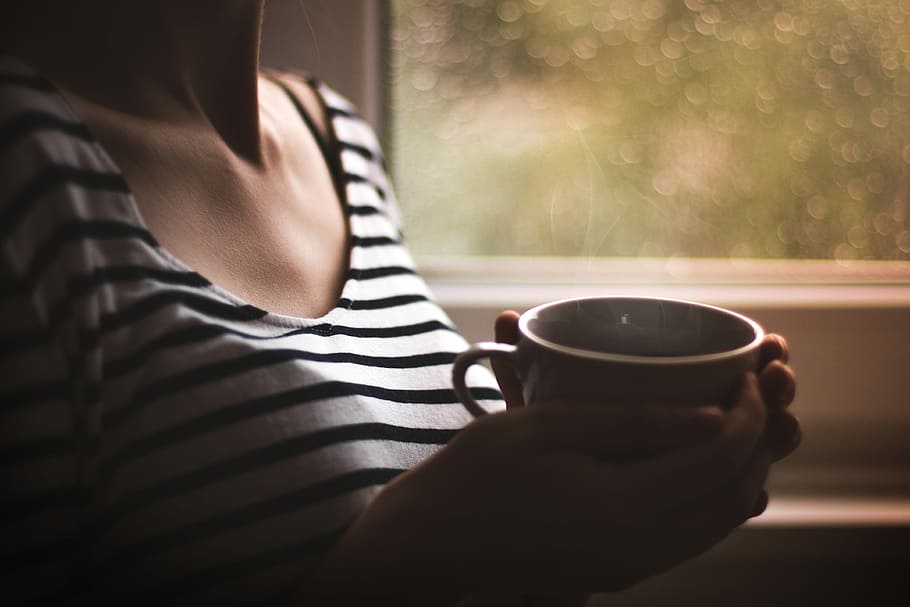 woman in black and white striped top holding white ceramic mug, person holing ceramic cup HD wallpaper
