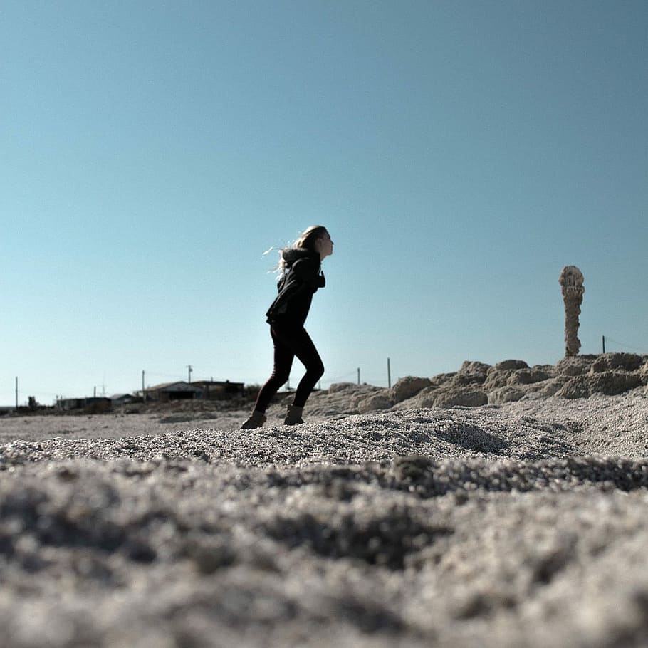 woman in black jacket and skinny jeans walking uphill, outdoors HD wallpaper