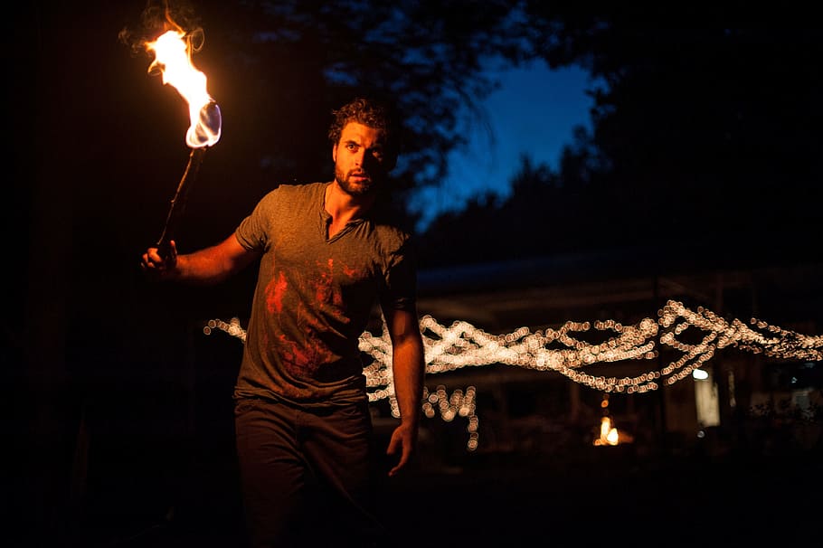 man holding torch, people, guy, fire, flame, dark, night, light, HD wallpaper