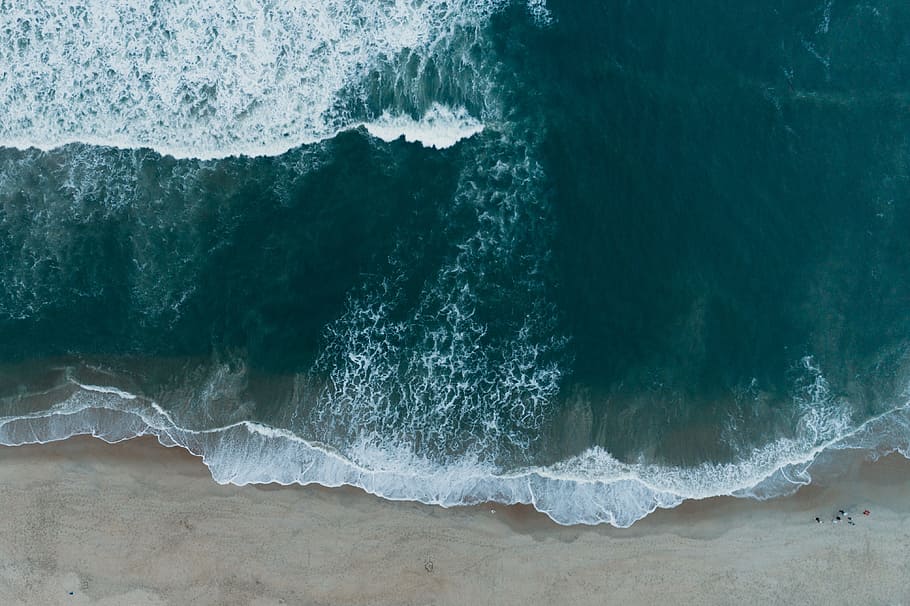 teal seawaves on seashore, top angle view photography of beach