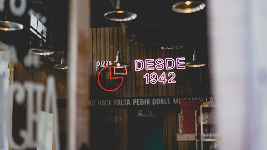 selective focus photo of desdes 1942 neon light signage, Desde 1942 neon signage