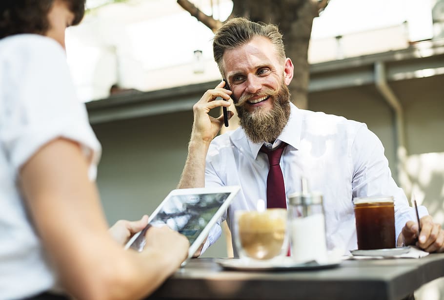 man wearing white dress shirt and maroon necktie sitting by the table HD wallpaper