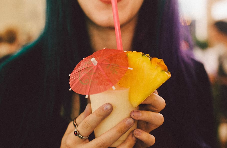 woman drinking shake using straw, woman sipping on fresh fruit juice