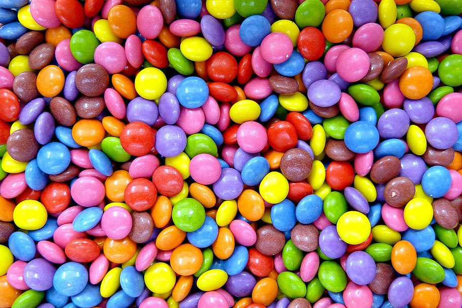 pile of nips candis, smarties, confectionery, lenses, multi colored