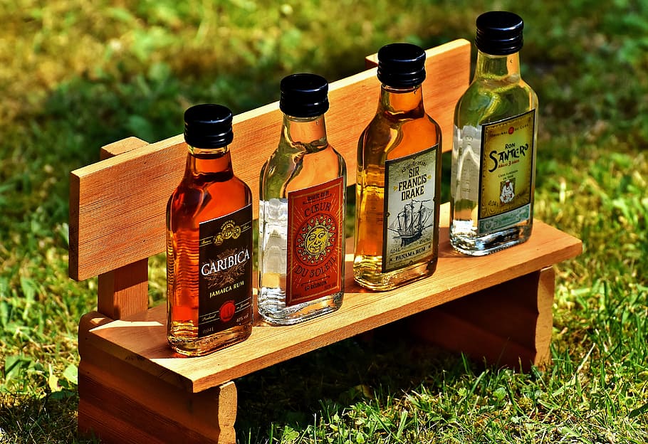 four glass bottles, Rum, Alcohol, Origin, different origin, alcoholic beverage