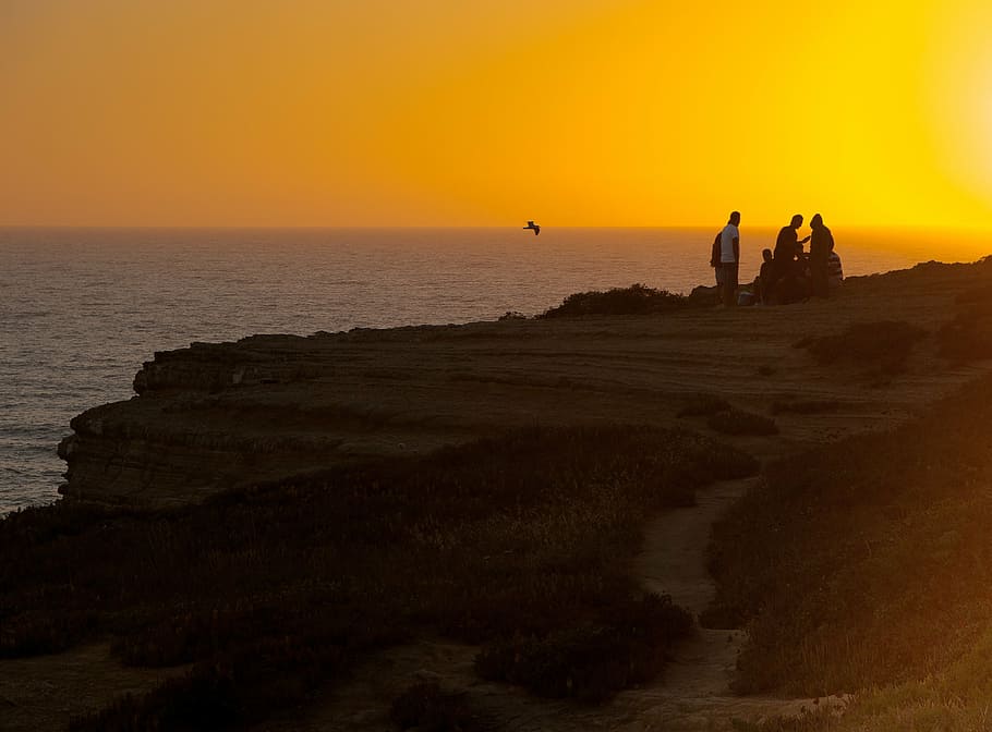 people on cliff, sunset, ocean, horizon, silhouette, sea, scenics HD wallpaper