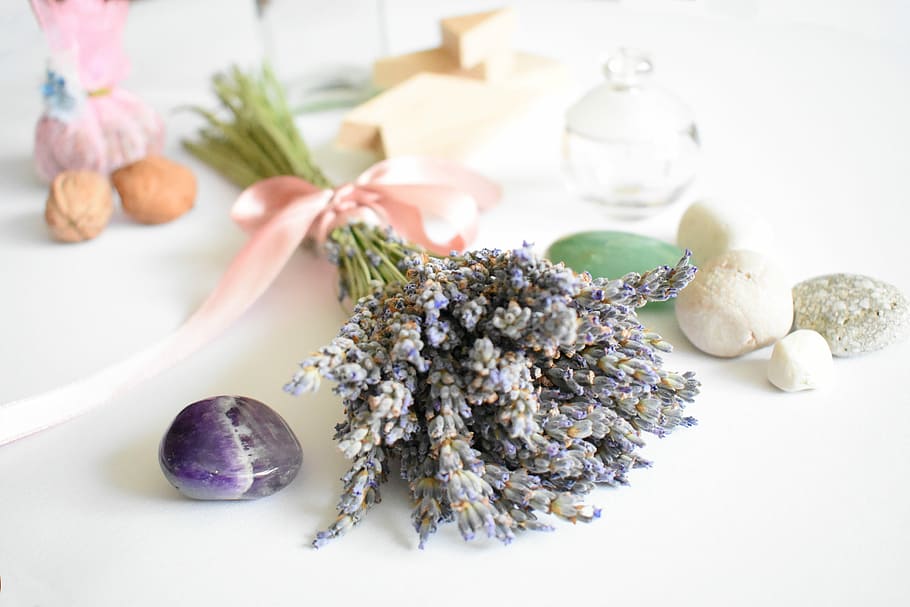 purple lavender flowers and colored stones on white surface closeup photography HD wallpaper
